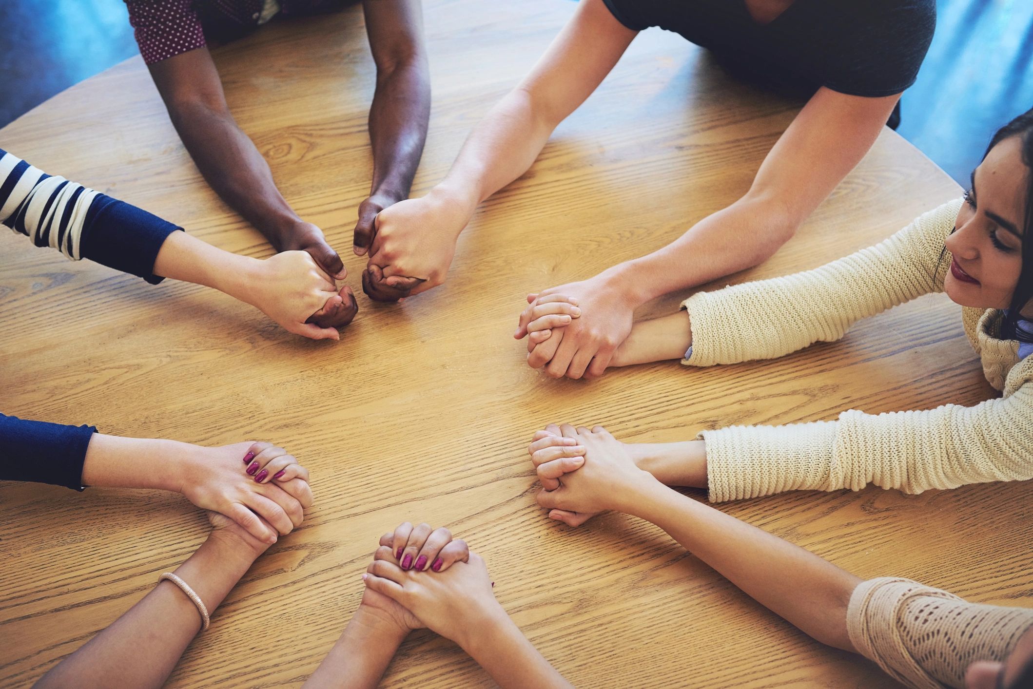 Community members joining hands in fellowship